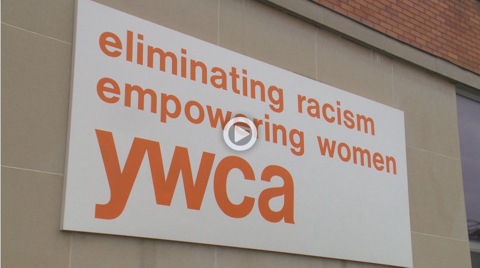 A YWCA sign hanging on the exterior wall of the new chapter building